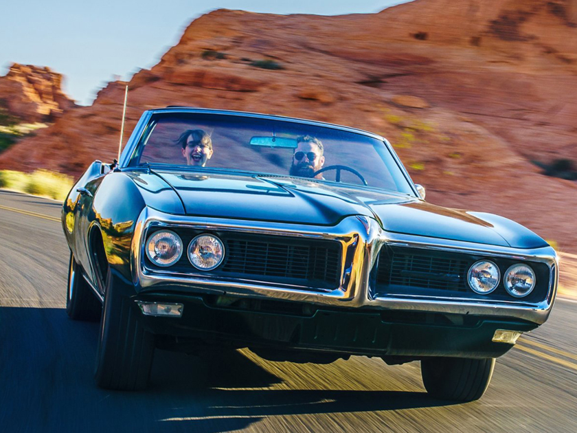Convertible car cruising in the desert