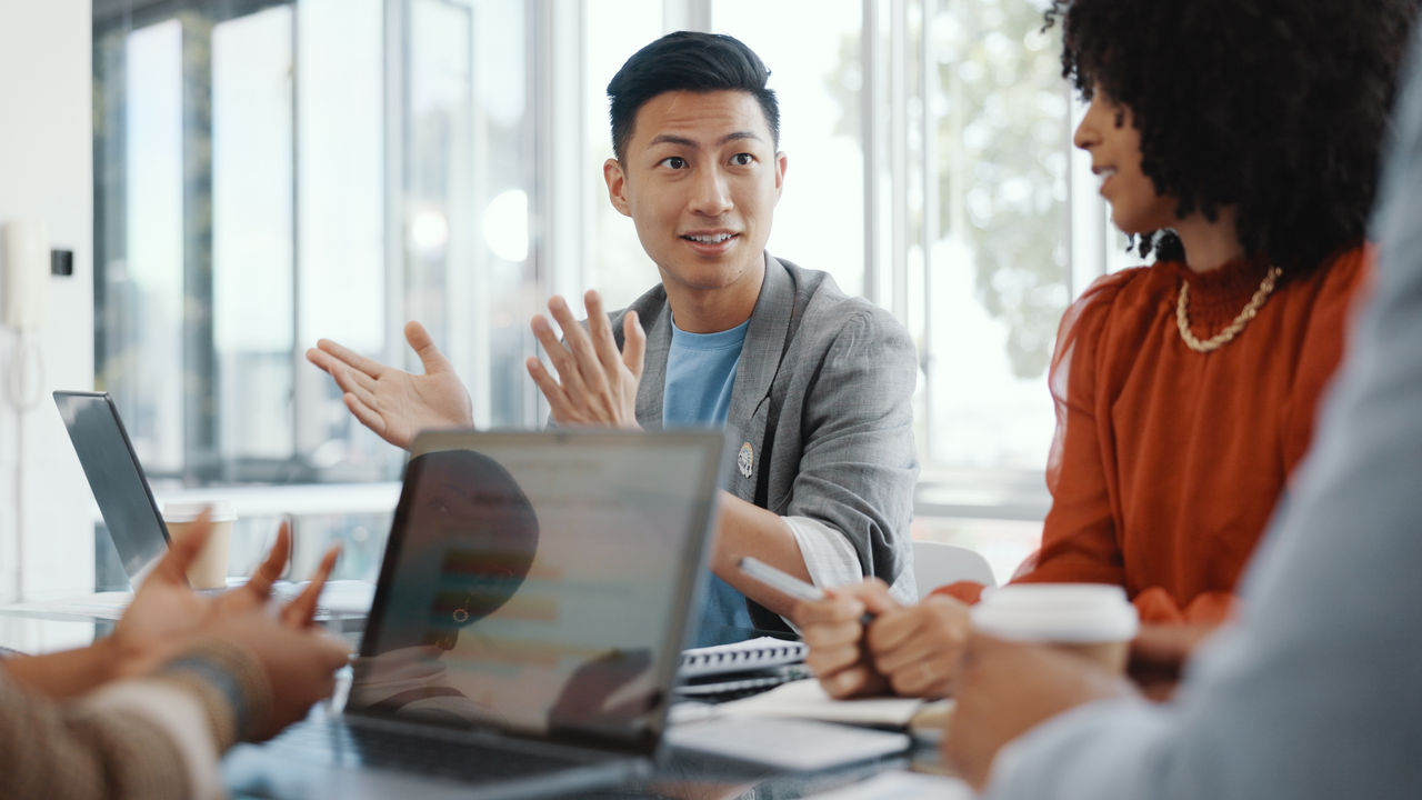Meeting, collaboration and team planning a project together in the office conference room. Teamwork, diversity and business people in discussion while working on a b2b corporate strategy in workplace - 16x9