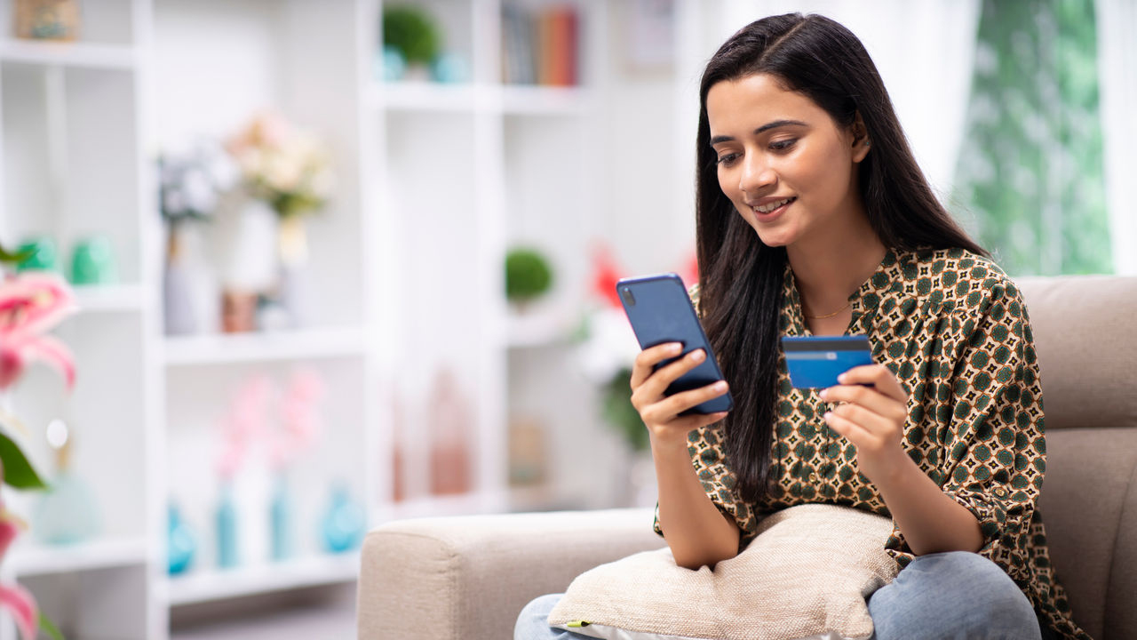 Woman doing a credit card transaction on her phone.
