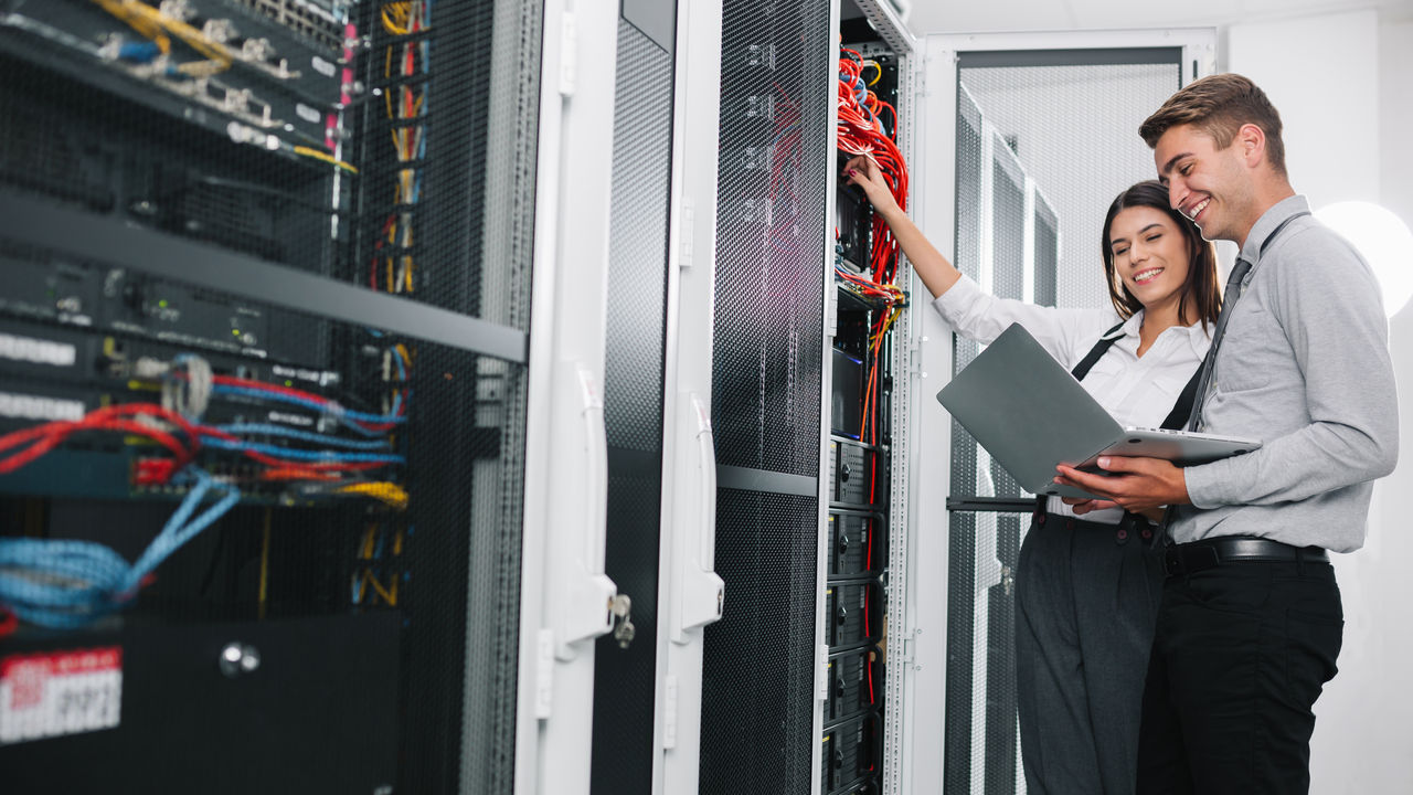 Team of technicians working together on servers at the data centre