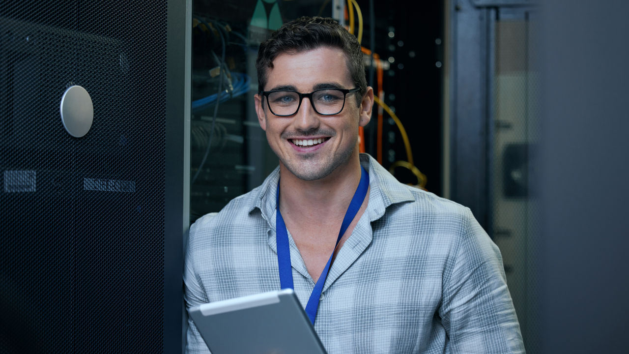 Engineer, server room and portrait of a man with a tablet for programming, cybersecurity or maintenance. Technician person in a datacenter for network, software or system upgrade app with technology.